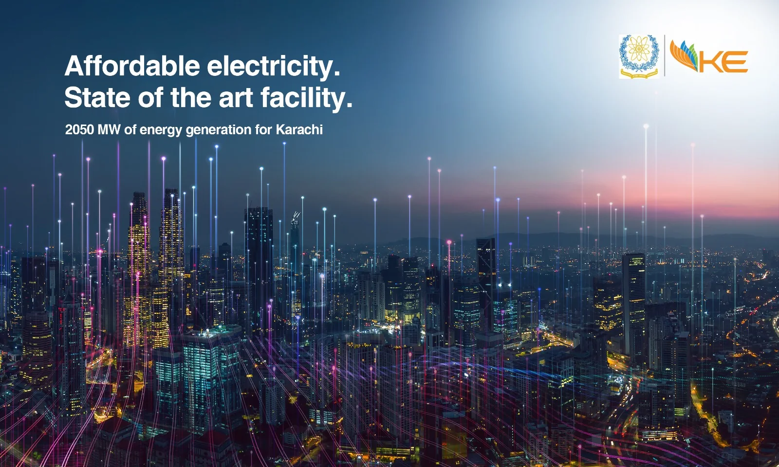 KE KANUPP backdrop: Affordable electricity. State of the art facility, over a lit-up skyline
